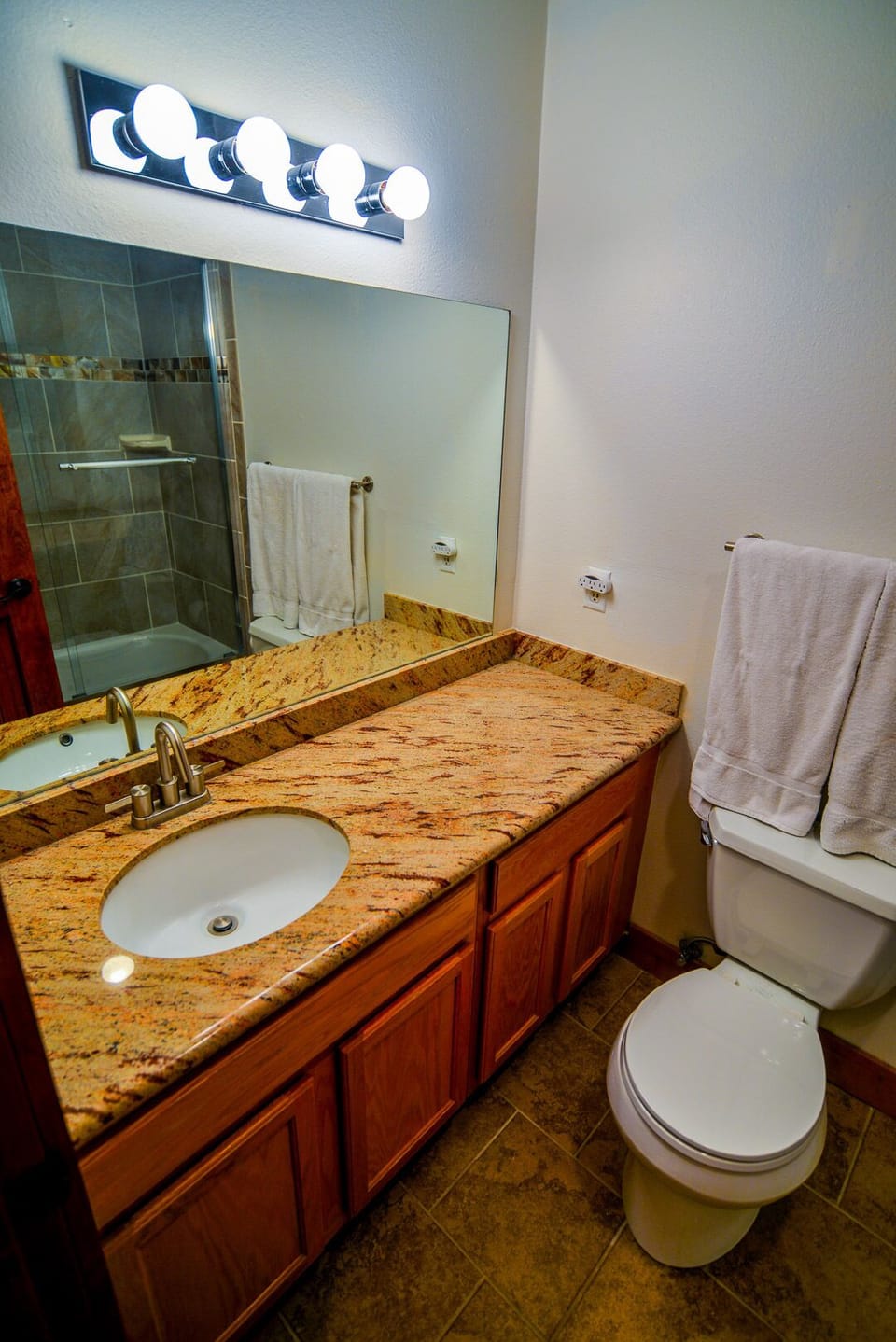 Granite vanities  throughout provide a clean and upscale feel