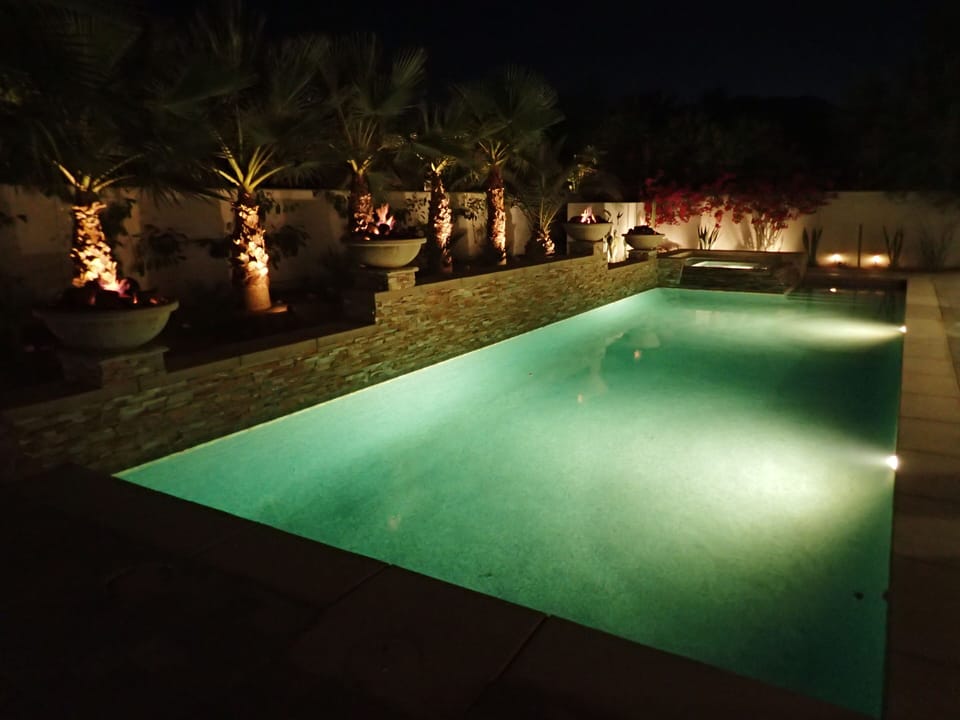 Pool at night, with fire bowls!
