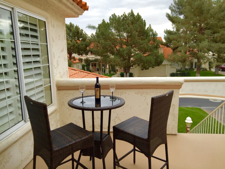 Front balcony with views of Santa Rosa Mountains with glass table bistro set