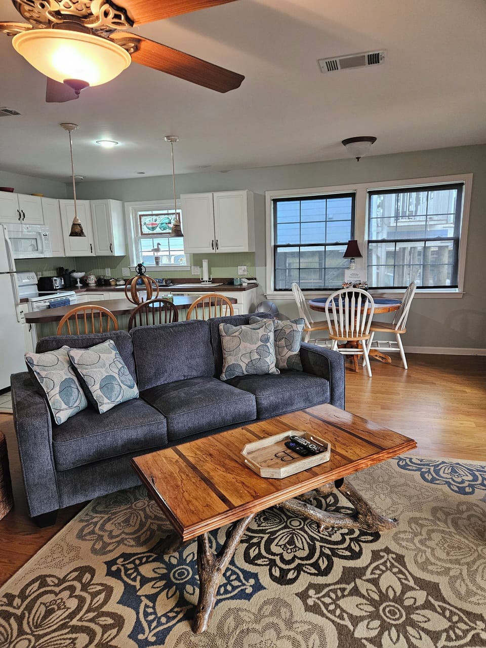 Welcome inside to an open living room, kitchen, and dining area.