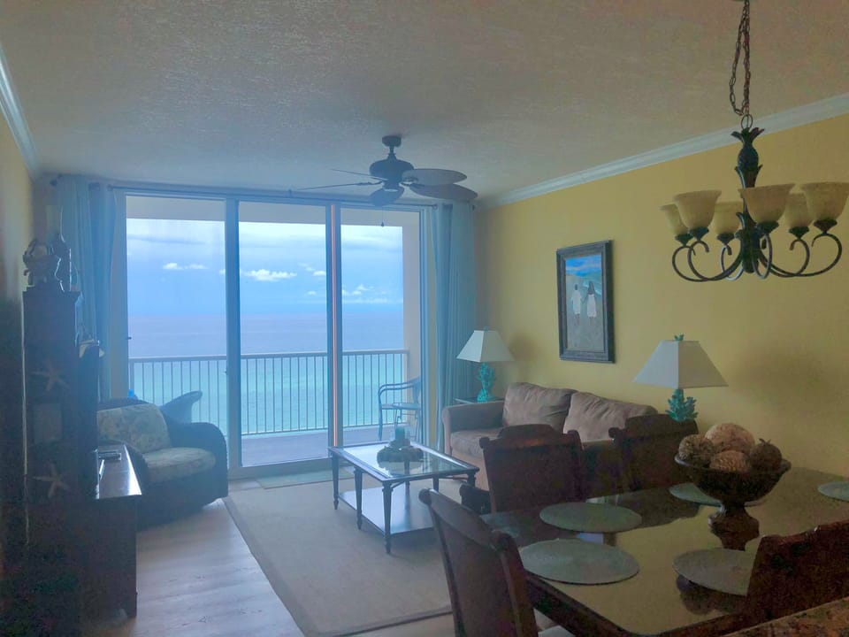 Living room with access to balcony and view of the ocean