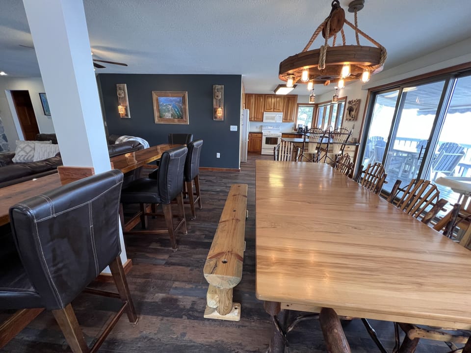 Dining seating includes 6 chairs, 4 at the bench, 2 at bar, and 4 at sofa table.