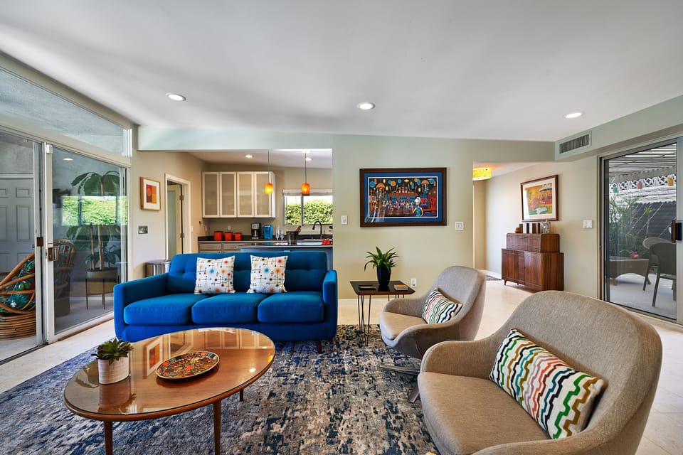 Comfortable living room with mid-century decor and art. Queen sleeper sofa.