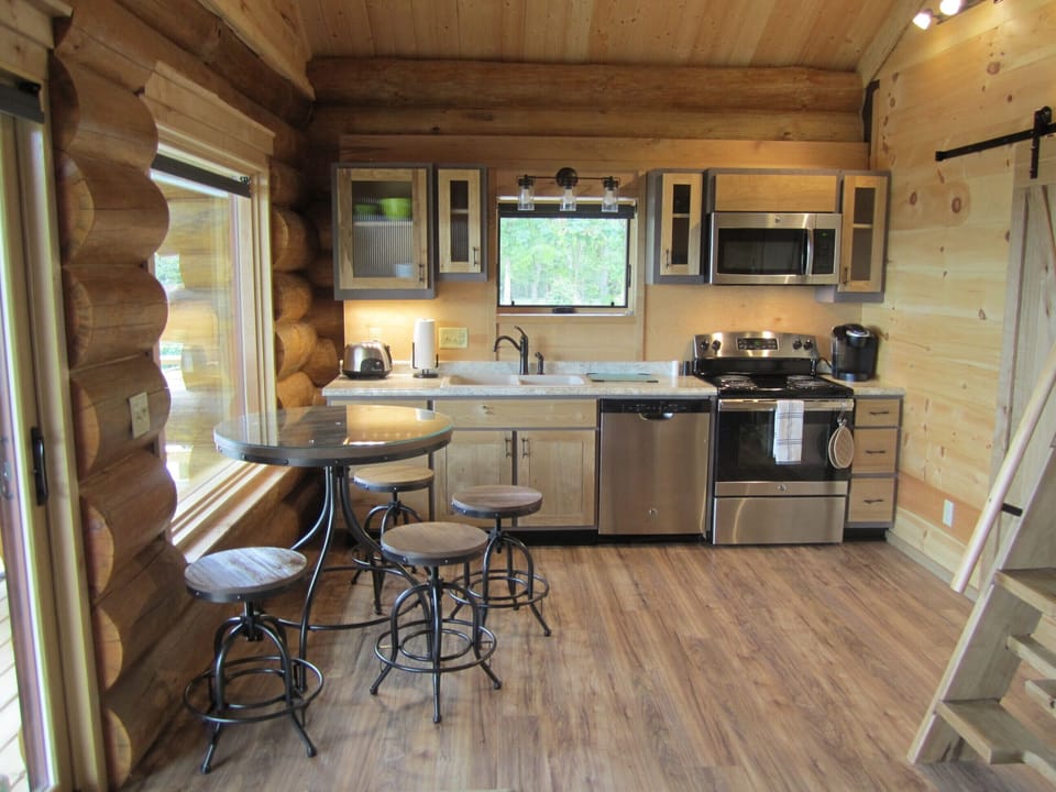 Fully equipped kitchen includes dishwasher, stove, fridge, and microwave.