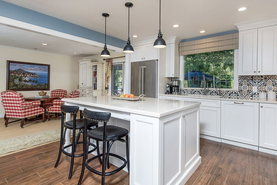 Kitchen open to living area with huge island for gathering together.