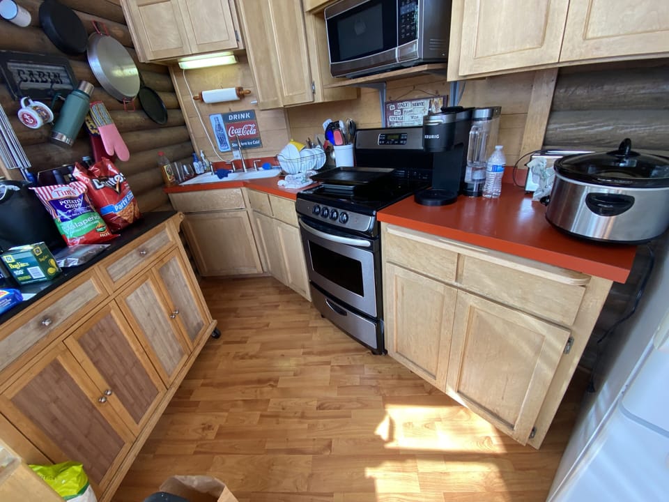 Kitchen: stove, microwave & fridge. Dishwasher attached to the end of your arms