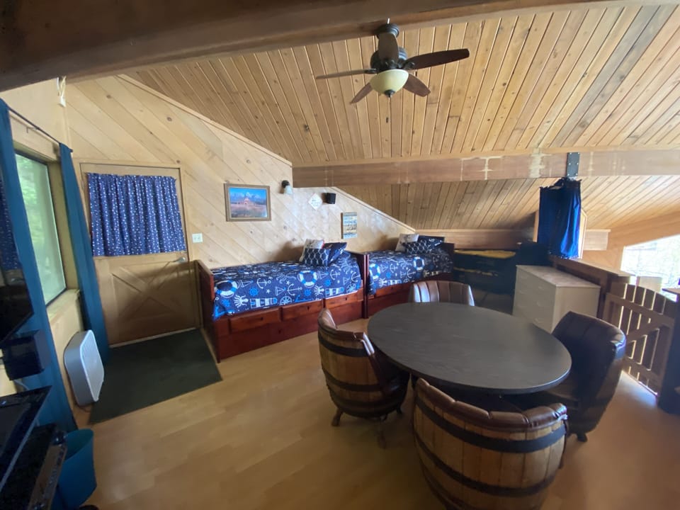 Loft has 4 twins (2 are trundle beds) a game table, TV and full size futon.