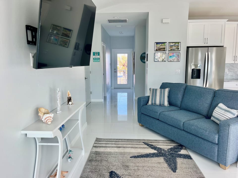 Living room with queen sofa bed and 65-inch TV