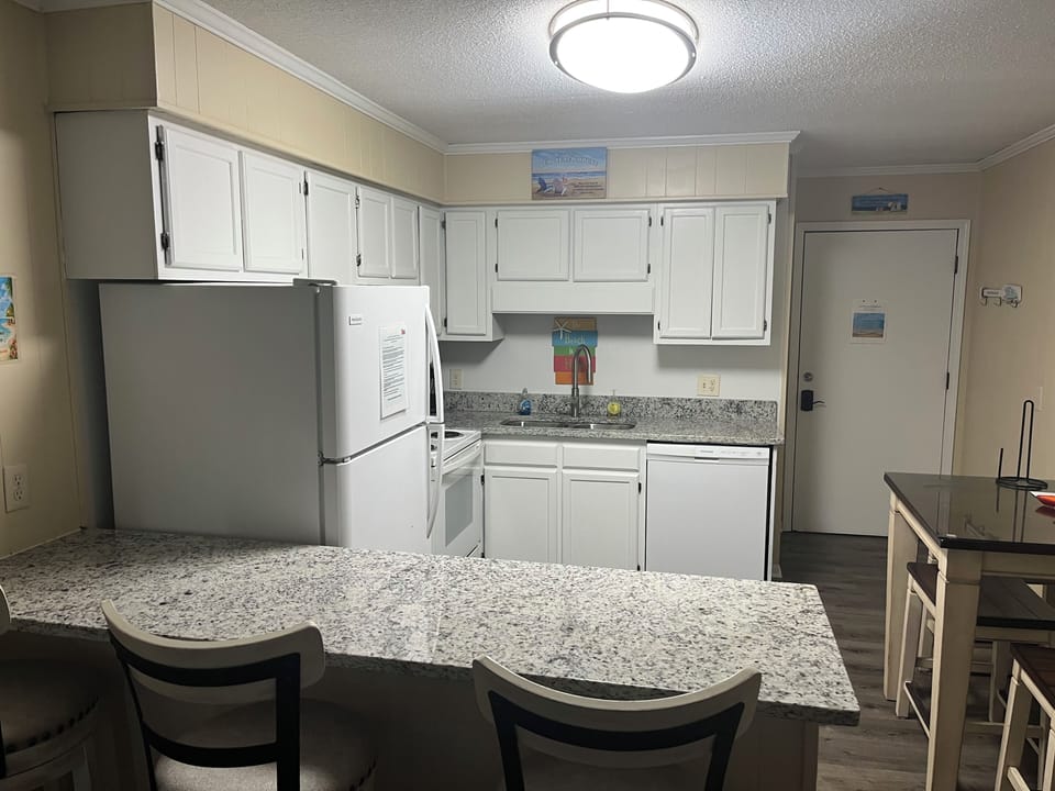 Updated kitchen with granite countertops. 