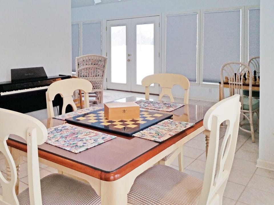 Back porch doors lead to the back yard & 1st tee of golf course! Walk to  pool!