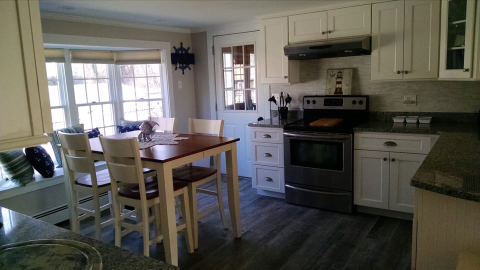 kitchen table is shown without table leaf and sits up to 8 people comfortably.