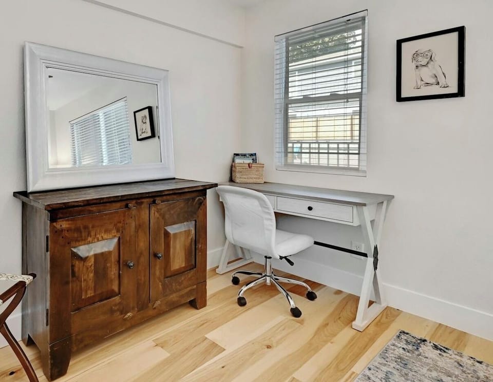 Third bedroom with queen bed and workstation with view of pool