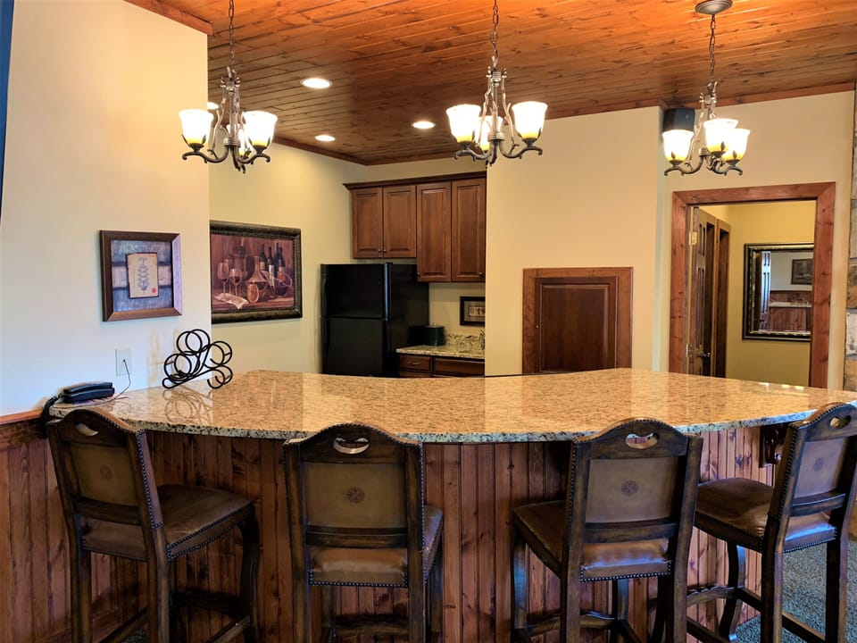 Bar area with 2nd refrigerator, sink and under counter ice maker.