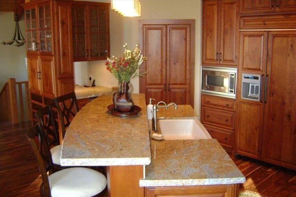 The kitchen offers plenty of counter space for cooking and prepping, with convenient bar seating for casual meals or conversations