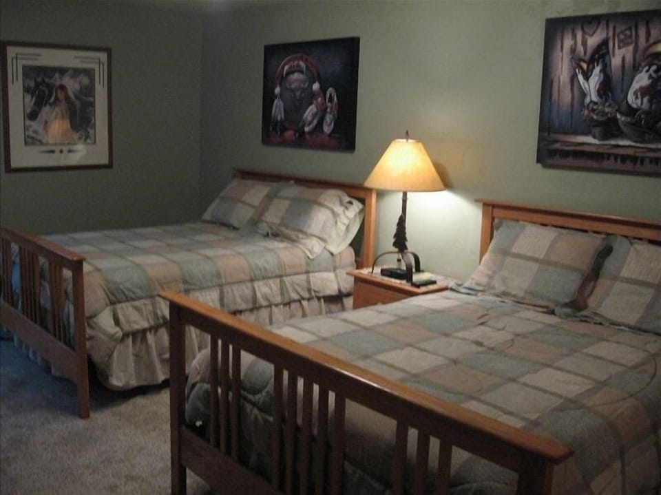 Large 2nd bedroom with two double beds and an attached full bath
