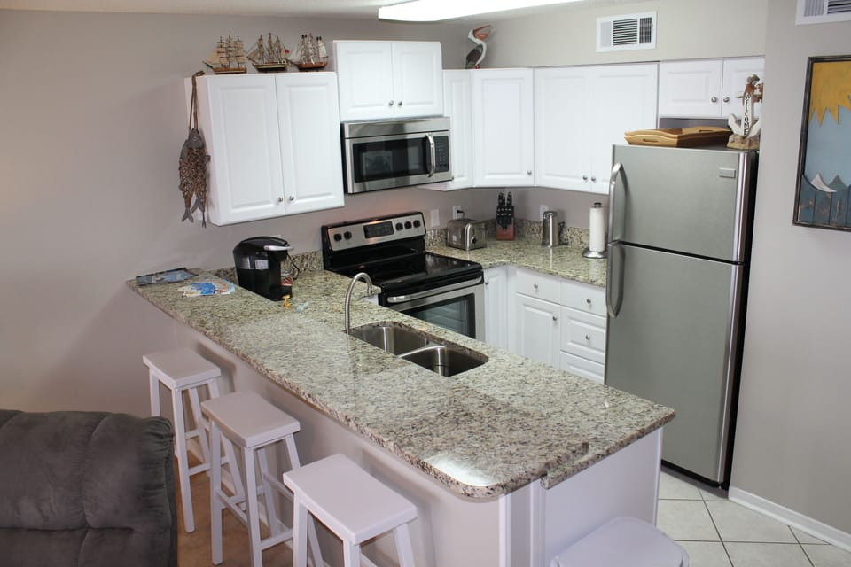 New granite countertops and stainless steel appliances.