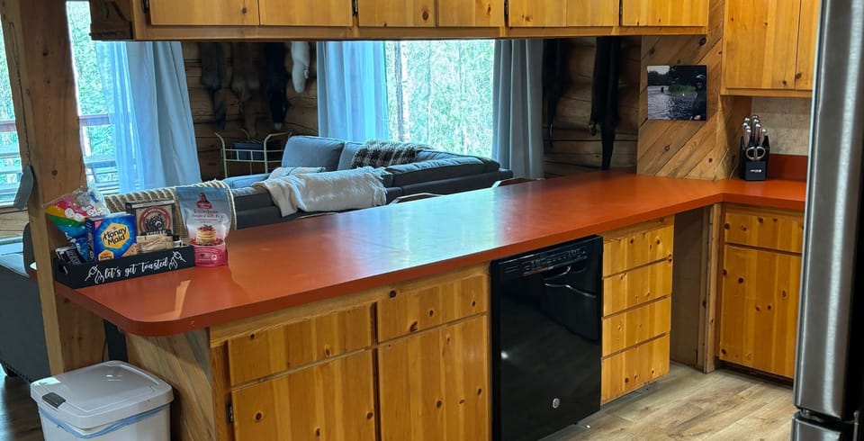 Kitchen opens up to living room, giving you full view of the Kenai River.