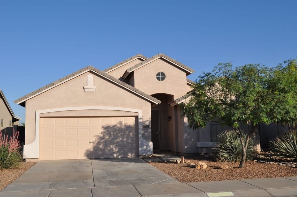 Beautiful landscaping surrounds the home located in a private quiet cul-de-sac