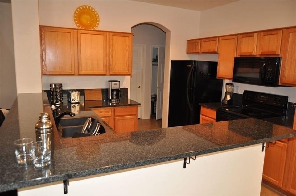 Kitchen open to family room & dining area - amazing view of pool & golf course