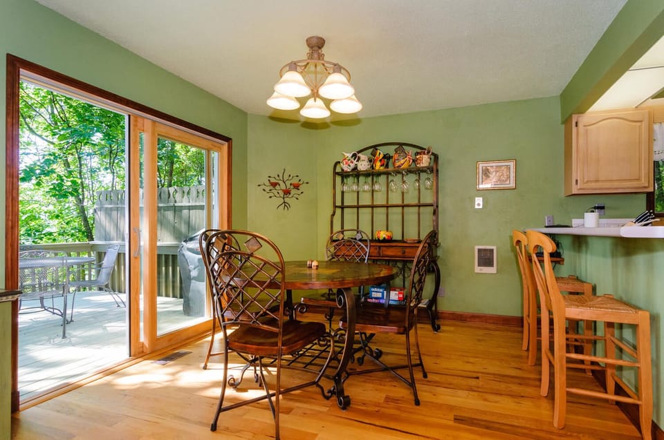 Dining area off kitchen with bar stools for additional seating.