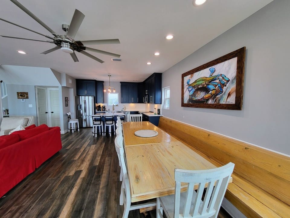Large dining table seats 16 comfortably with bench and chair seating.