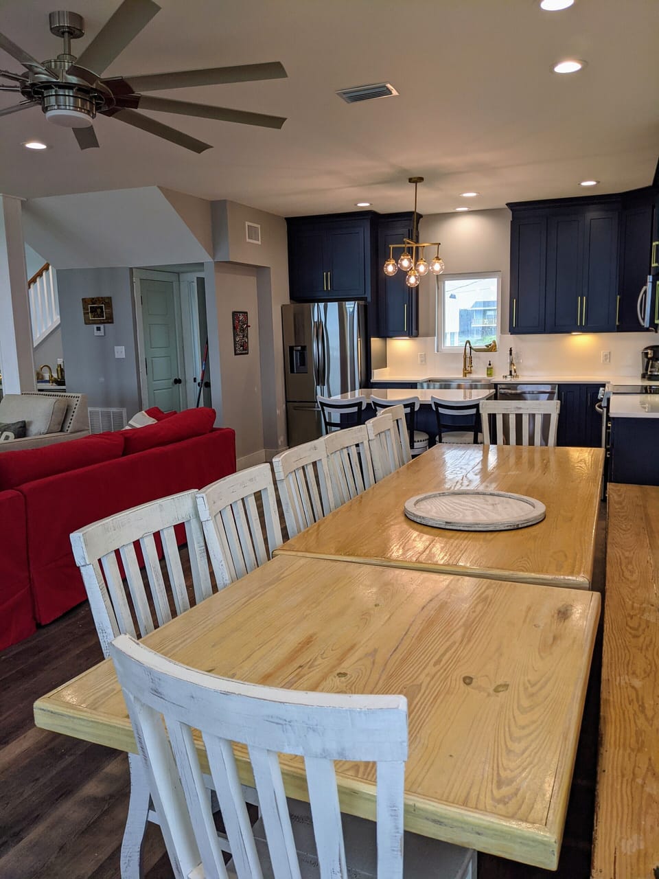 Large dining table seats 16 comfortably with bench and chair seating.