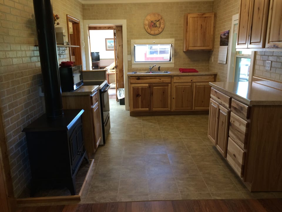 Kitchen has all new cabinets and propane heat stove is cozy!