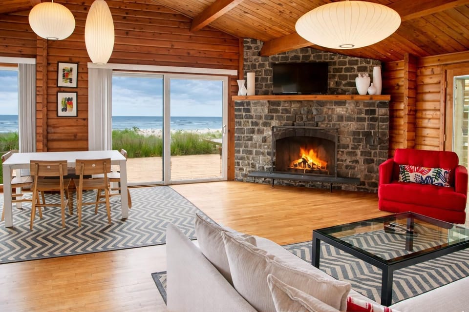 Modern Manzanita rental with open living, stone fireplace, and ocean views—designed for comfort and connection by the coast