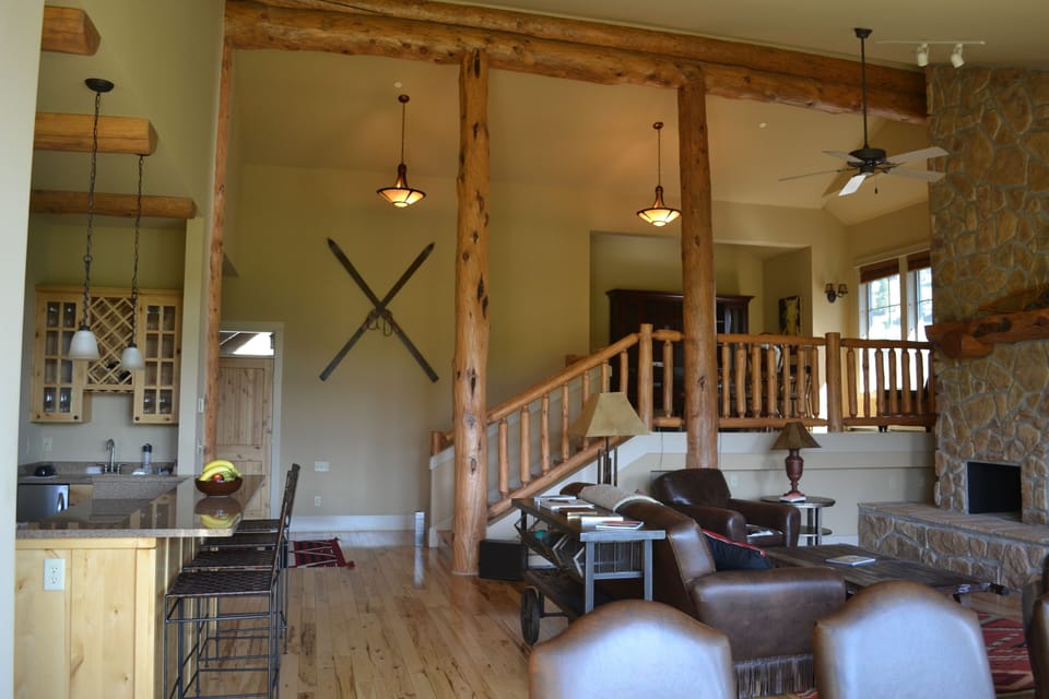 view from dining room to living room and loft, where there is a game table