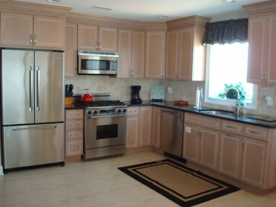 Fully stocked kitchen with Dacor stainless steel appliances.