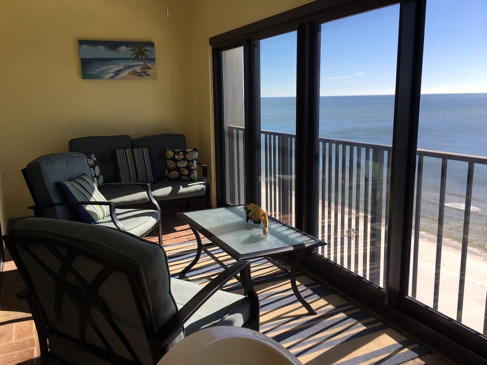 Balcony with comfortable seating and patio table with chairs for four 