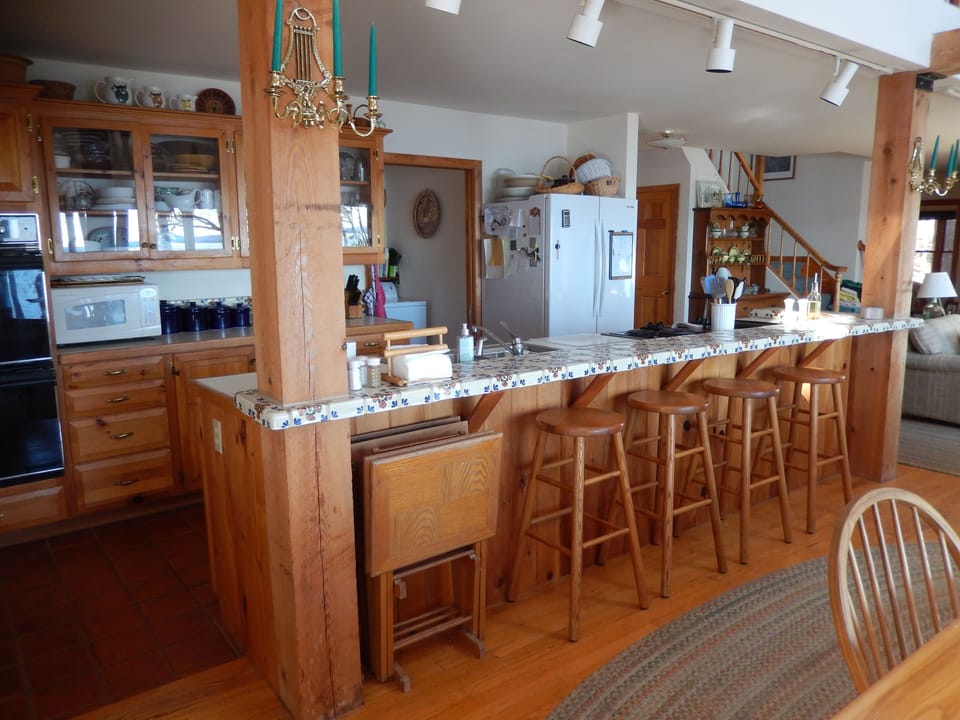 Counter and stools between kitchen and dining area.