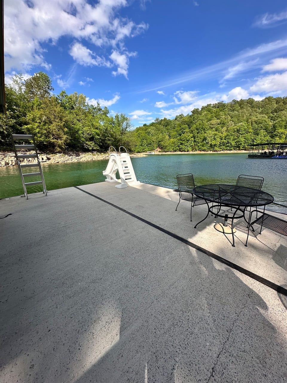 Spacious boat dock with 48" slide, patio table and chairs, and the latest staircase style ladder.