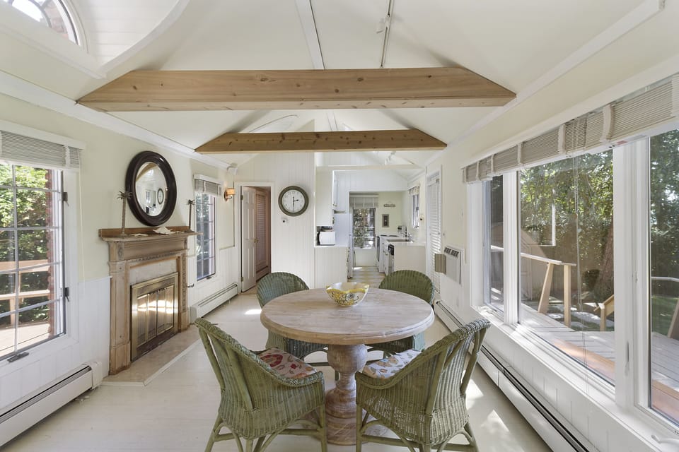 Breakfast table off the kitchen facing the water with a 2nd fire place to enjoy