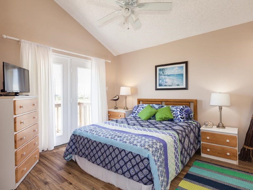 Queen guest room with private deck, connects to Jack and Jill bath.