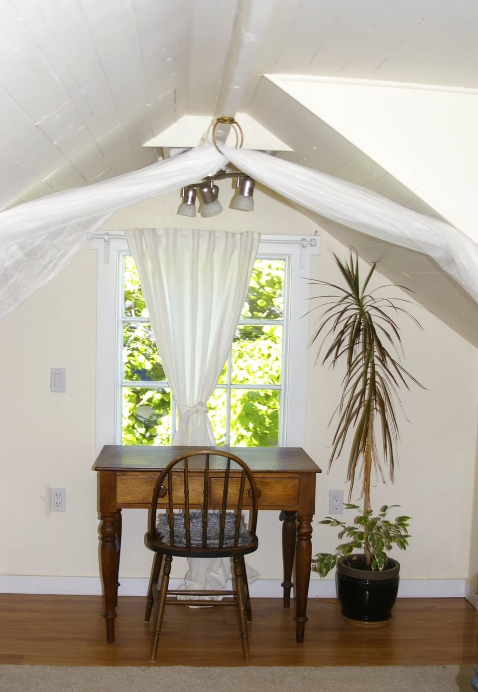 The master bedroom is large with a private workspace.