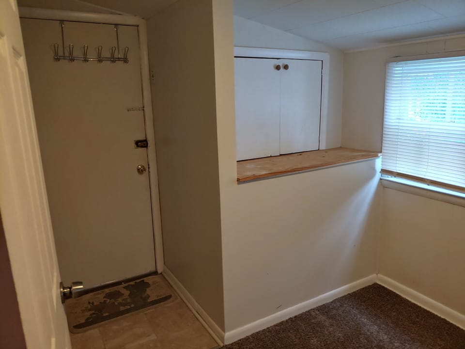 Downstairs back bedroom with door to back porch