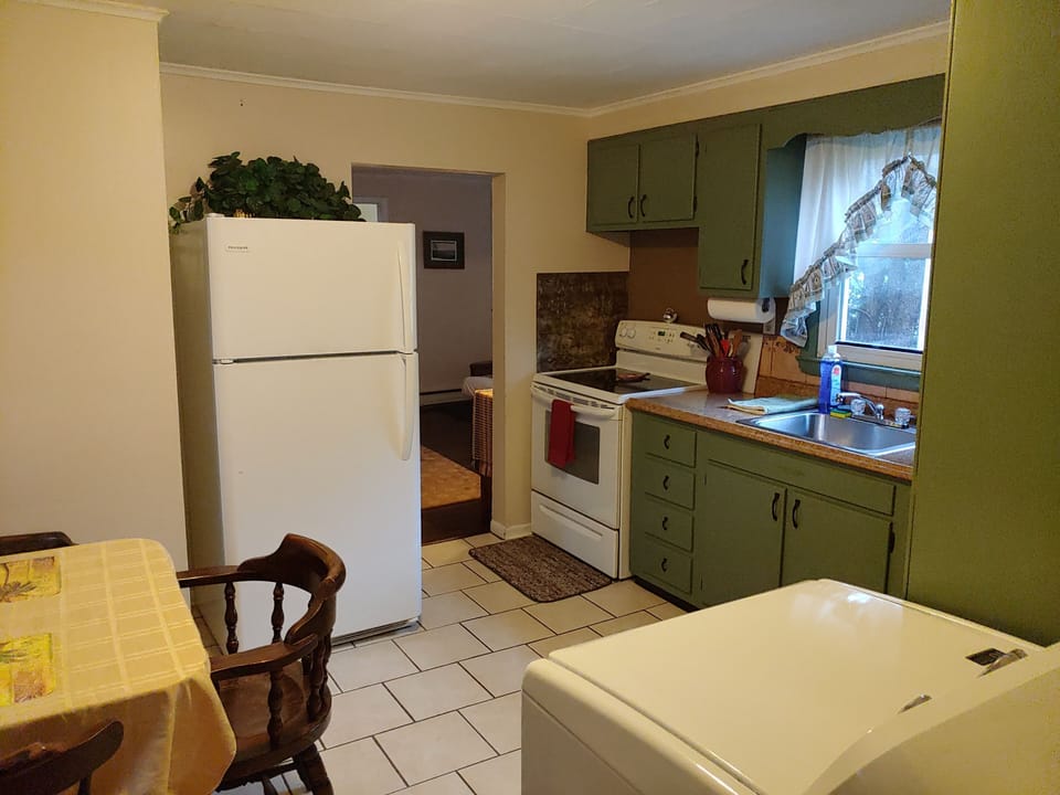 Kitchen with enrty room visible 