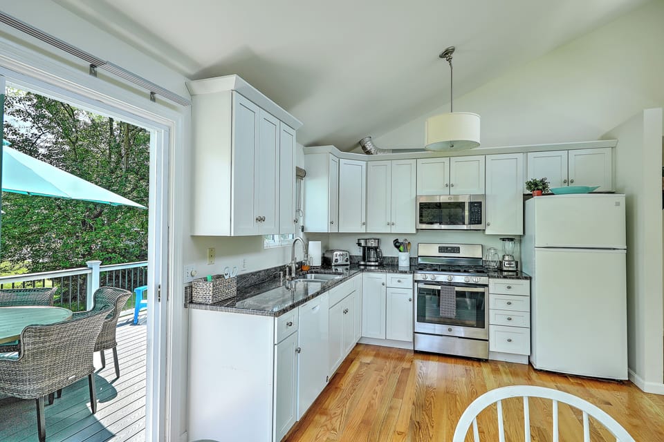 Kitchen with sliding door leading to outside deck 