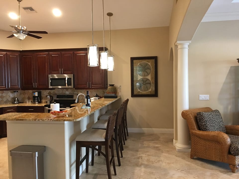 Comfortable seating for four at large granite breakfast bar