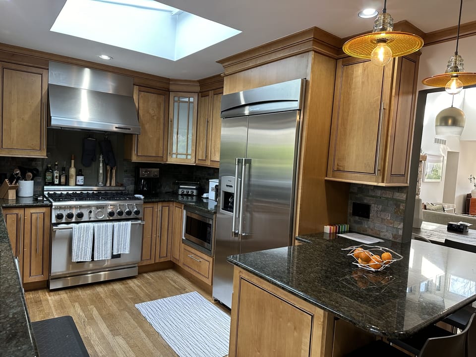 Beautiful kitchen with all high-end appliances looking out over the pool