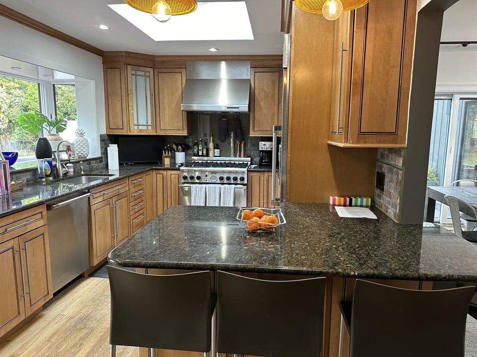 Kitchen with counter seating looking out to pool