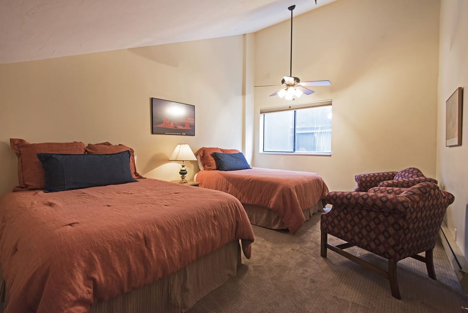 Master bedroom with two queen beds, chair and TV (not shown)