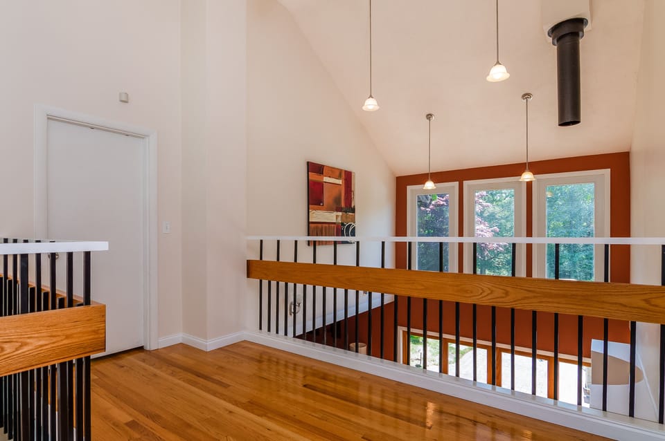 The upstairs landing overlooks the living room and contributes to the open feel