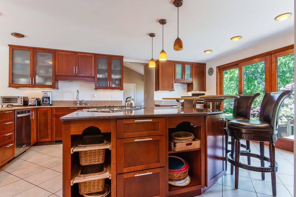 Small appliances, utensils, pots and pans all ready and available in the kitchen