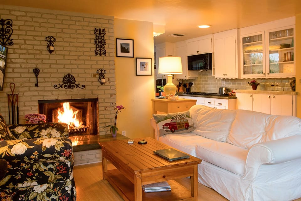 Wood burning fireplace in Family Room next to kitchen with Queen sleeper couch