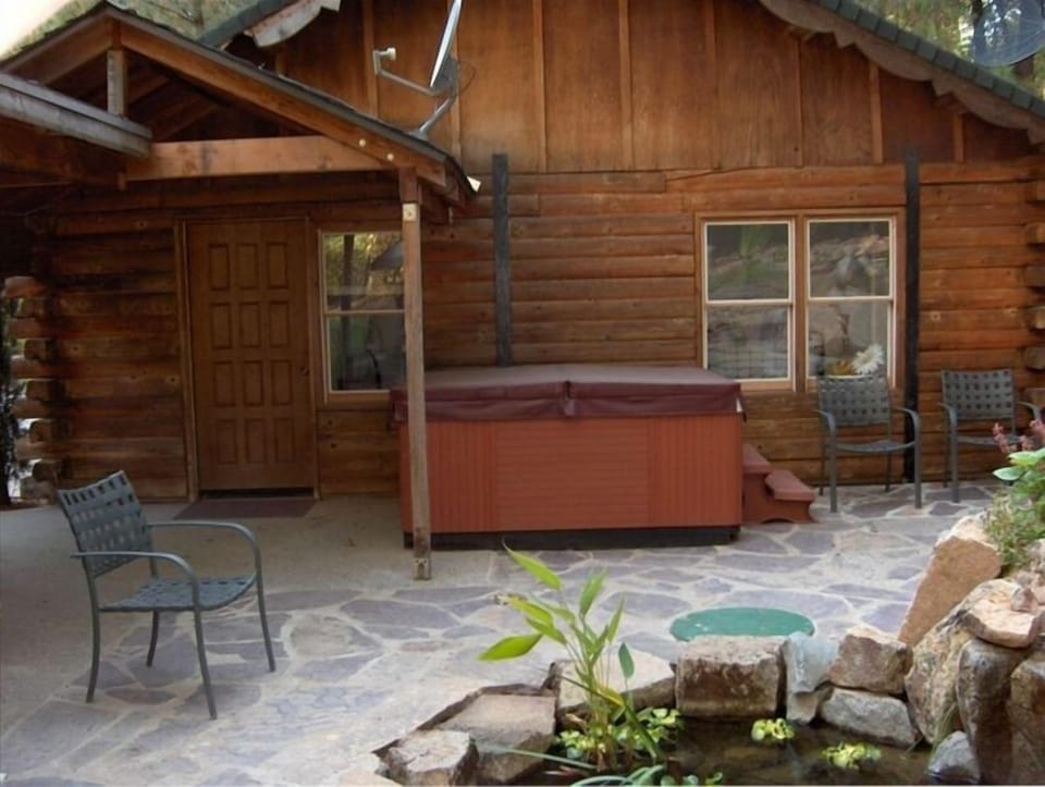 Back patio area with pond and hot tub of bedroom.