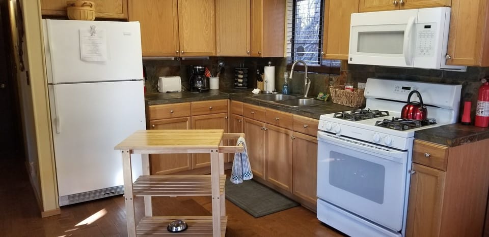 Open kitchen with everything you need. Pots, pans, utensils, crockpot, coffee..