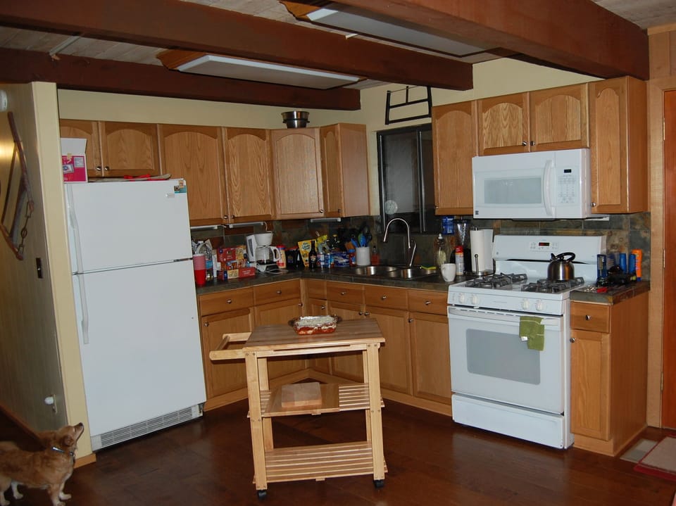 Full kitchen including cutting board island on wheels for easy prep.