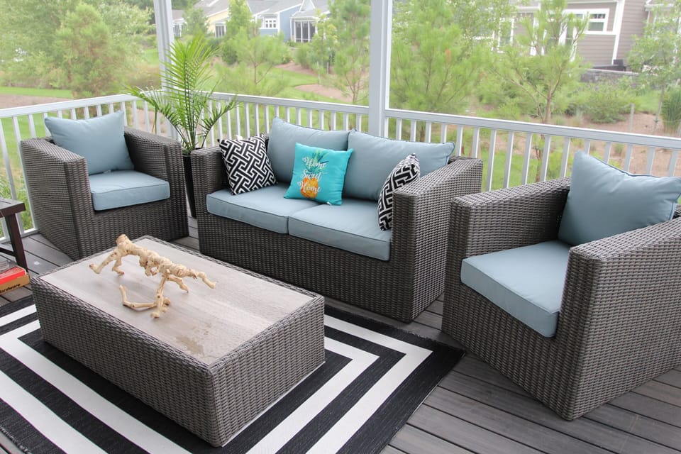 Comfortable seating area of screened in porch to soak in the refreshing breeze